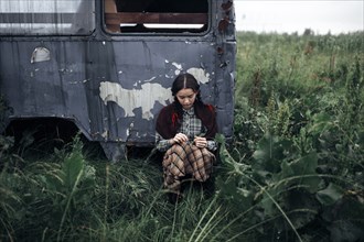 Caucasian woman sitting near antique truck