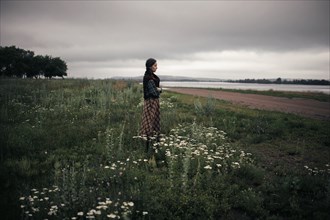 Caucasian woman standing in remote field