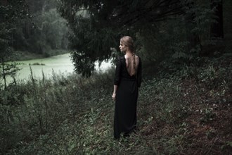 Caucasian woman standing on forest hillside
