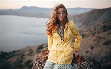 Caucasian woman standing on coastal hillside