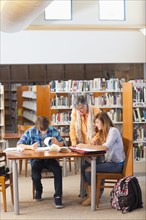 Librarian helping students in library