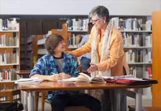 Librarian helping student in library