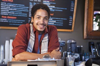 Mixed race man working in coffee shop