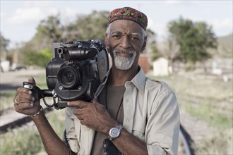 African American man using film camera