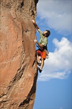 Caucasian man climbing rocks