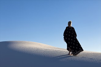 Caucasian woman walking in desert