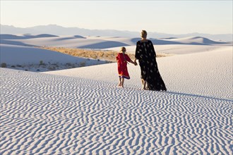 Caucasian mother and daughter walking in desert