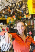 Caucasian woman standing in bicycle shop