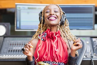 African American singer listening to track in studio