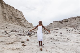 African American woman standing in rock formations