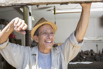 Middle Eastern man smiling in workshop