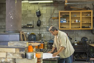 Middle Eastern man working in workshop
