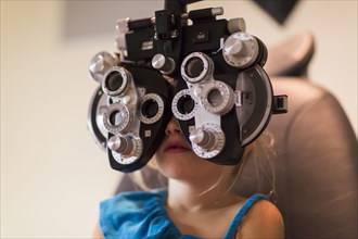 Caucasian girl receiving eye exam