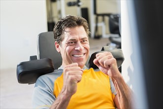 Caucasian man exercising in gym
