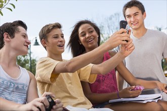 Teenagers taking self-portrait together outdoors