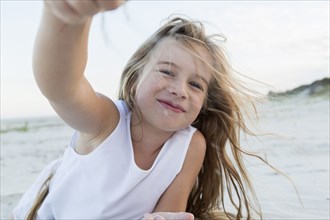 Girl playing in sand on beach