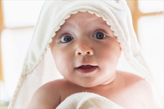 Caucasian baby wrapped in towel