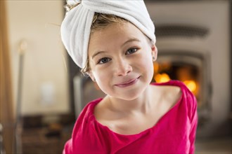 Caucasian girl smiling with towel wrapped on head