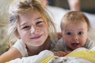 Portrait of smiling Caucasian girl with baby brother