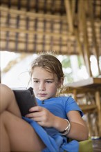 Caucasian girl using digital tablet on patio