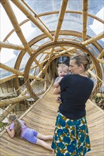Caucasian mother and children in bamboo tunnel