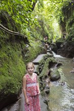 Caucasian girl smiling in tropical rainforest