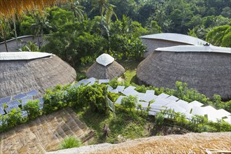 Solar panels among thatched roof buildings