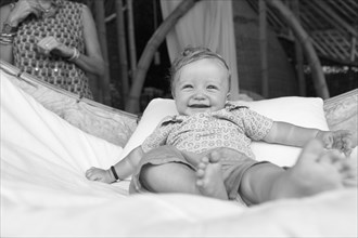 Caucasian baby smiling in crib