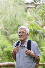 Senior Caucasian man walking in jungle