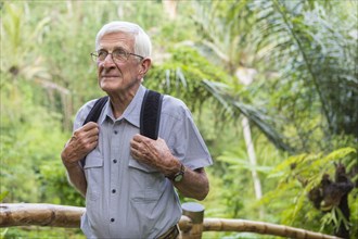 Senior Caucasian man walking in jungle