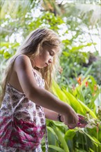 Caucasian girl admiring tropical plants