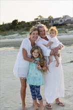 Caucasian family smiling on beach