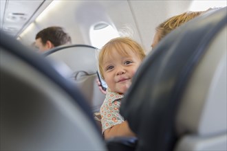 Caucasian baby laughing on airplane