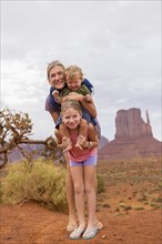Caucasian family smiling in desert