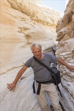 Older Caucasian man exploring rock formations