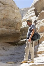 Older Caucasian man exploring rock formations