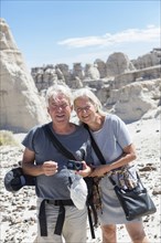 Older Caucasian couple exploring rock formations