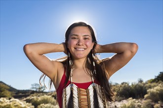 Mixed race woman smiling in remote desert landscape