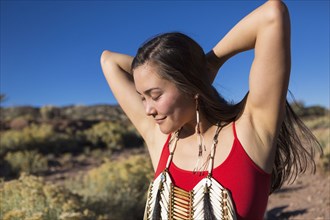 Mixed race woman standing in remote desert landscape