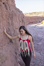 Mixed race woman walking in remote desert landscape