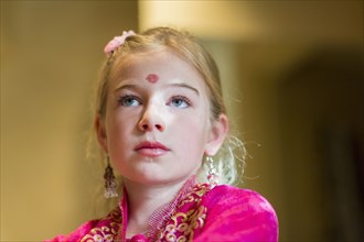 Caucasian girl wearing bindi on forehead