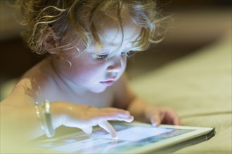 Caucasian baby using digital tablet