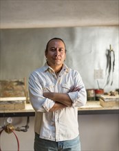 Native American jeweler standing in studio