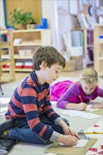 Caucasian children writing in classroom