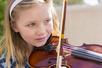 Close up of Caucasian girl playing violin