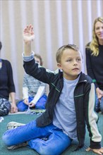 Boy raising hand in classroom