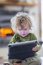 Caucasian baby boy using digital tablet