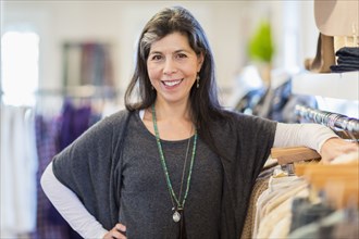 Hispanic small business owner smiling in store