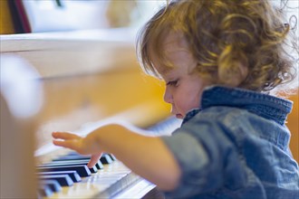 Caucasian baby boy playing piano