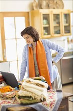 Hispanic business owner using laptop in home office